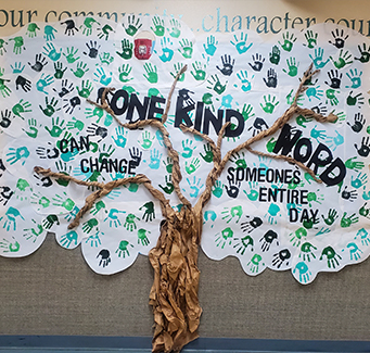 Paper tree that reads One kind word can change someones entire day.